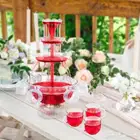 نافورة عصير كهربائية بلاستيكية مع 6 اكواب موضحة في الصورة