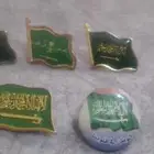 كلمتي التواحد شعار المملكة تعليقا للبدله والثياب