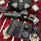 كاميرا كانون 1100D وعدسه 75-300 وملحقاتها