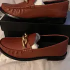 كوتش COACH (حذاء رسمي للدوامات)