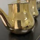 دله فضيه مع بريق فضي طقم وأباريق ذهبيه ومبرد قهوه ومركا صغير