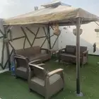 مظلة خيمة خارجيه مع كراسي تنفع في حديقه او سطح نظيفه عالسوم