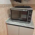 غرفة نوم وفرن كهربائي وماكينة غسيل سجاد