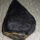 black stone in the shape of a spearhead..شكل رأس رمح