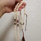 سبحة كهرمان لون عاجي مطعمة بكوك بني اصلي (جديدة) حبة كبيرة.