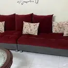 كنب للبيع مع طاولة كبيرة في الوسط وطاولة تلفزيون