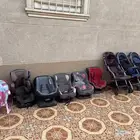 مجموعة من عربيات الأطفال وكراسي أطفال للسيارات