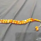 مسباح شبيه سندلوس باللون البرتقالي المموج 33 خرزه 100 ريال