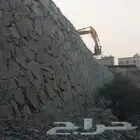 بوكلين لبناء الحجر وقص الأراضي وهدم العمائر
