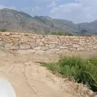 بكلين لقص الأراضي وبنا الحجر