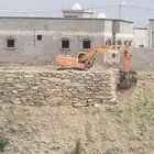 بوكلين لقص الاراضي وبناالحجر