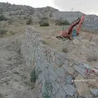 بوكلين لبناء الحجر وقص الاراضي في عسير