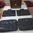 شنطة يدوية وشنطة لاب توب وحافظة دفتر وقلم مختلفة الأشكال