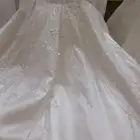 فستان عروس ابيض باكمام شفافه وحبل من الظهر