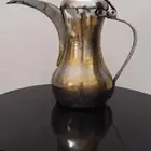 دله منقوش عليه سيفين و نخله