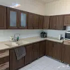Wooden themed kitchen cabinets with sink