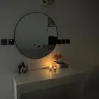 round mirror and dressing table