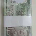 ربطة كاملة لعملة صدام حسين طبعة سويسرية