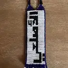 ميدالية مفاتيح بالاسم الاصلعي خرز