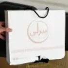 طباعه اكياس عبايات بوكسات حلويات لوقو عبايه تاق قماش ليبل قم